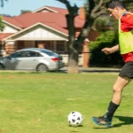 United Abilities client playing soccer during an NDIS group activity.